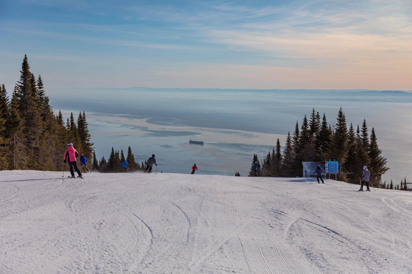 people skiing down run