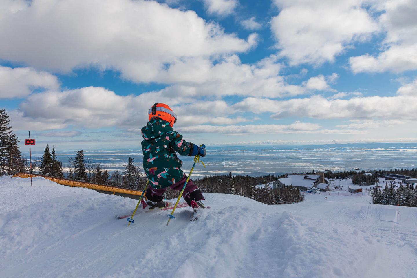 kid skiing off jump