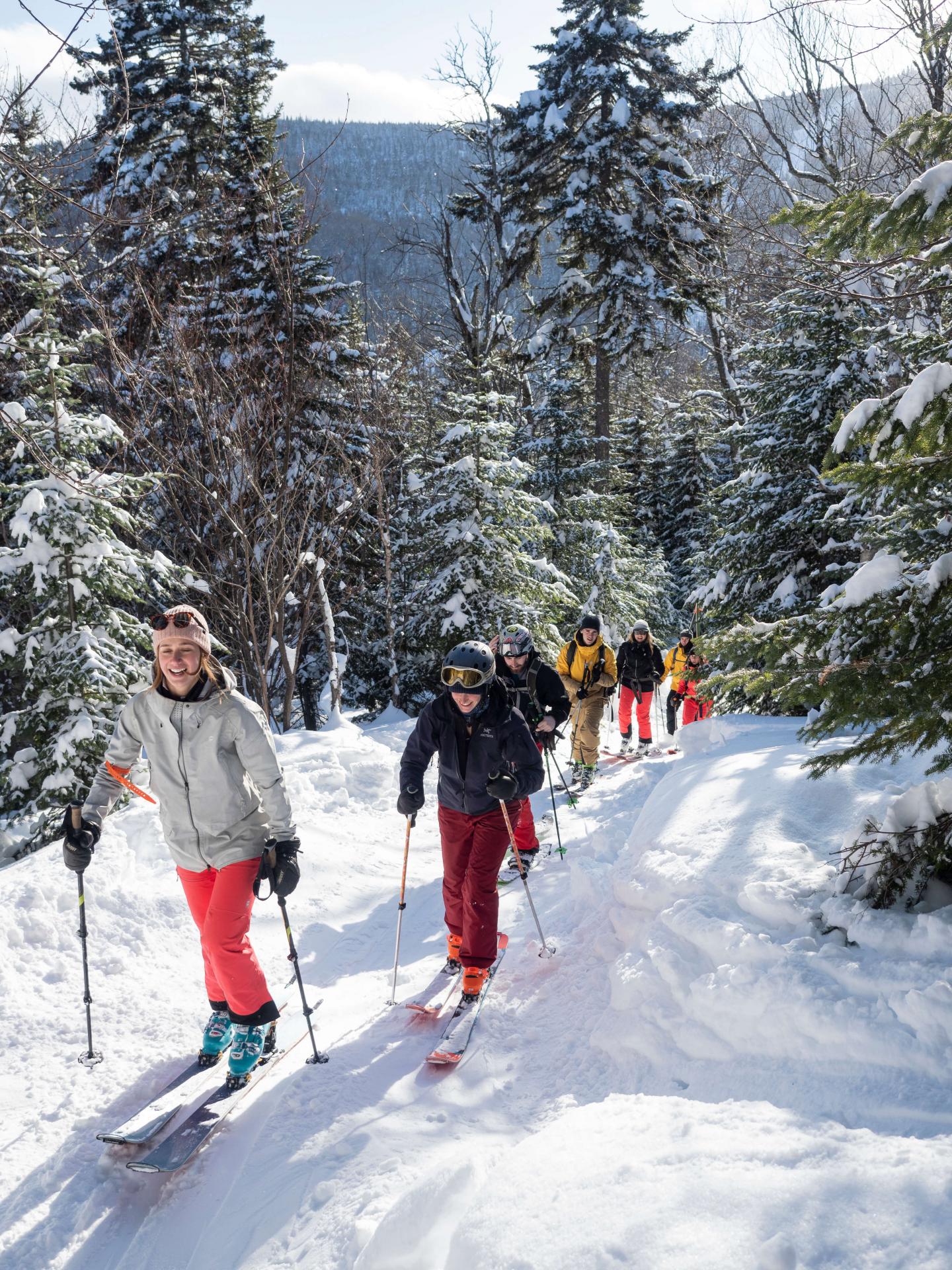 people hiking up mountain for skiing off-piste