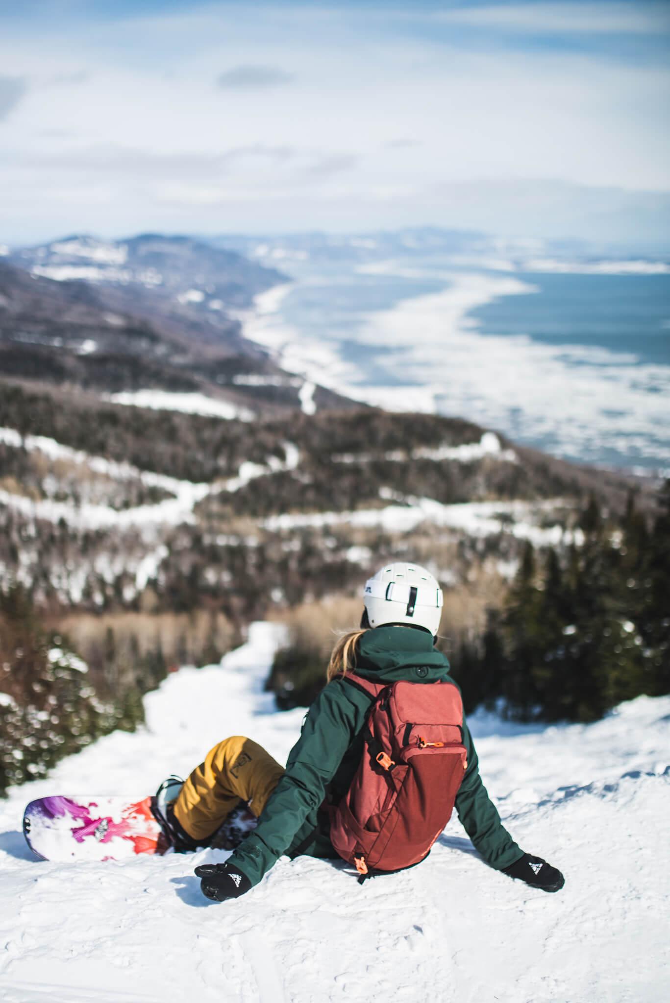 snowboarder taking a break before exploring all the great trails at le massif