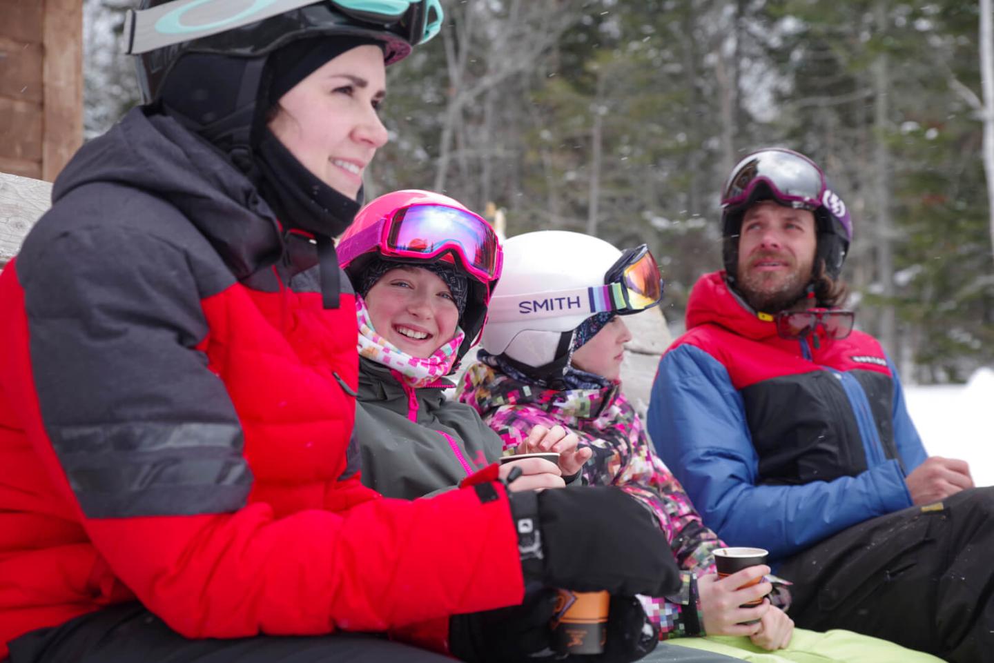 people having a great time in a group setting on the mountain in quebec