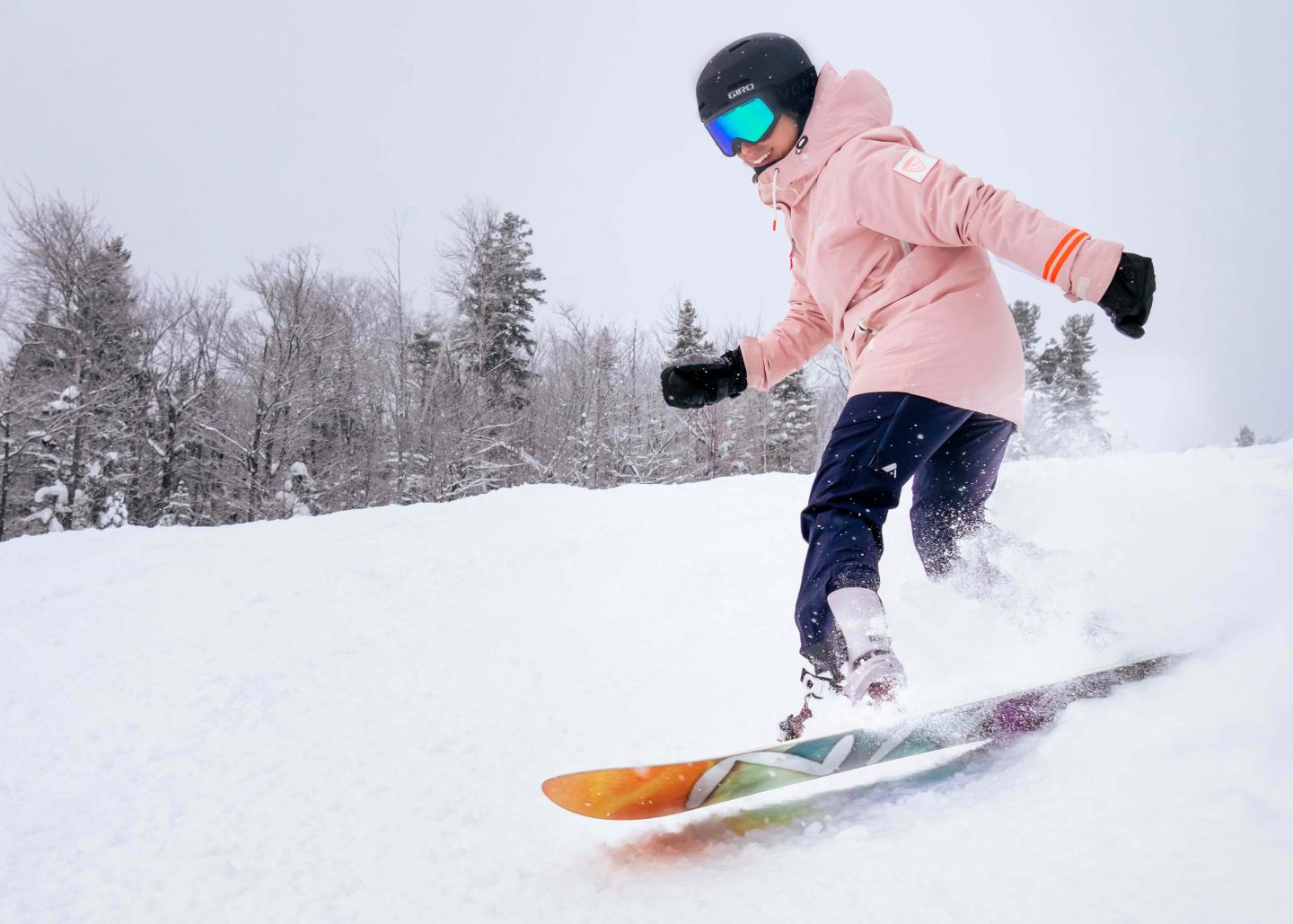 woman carves a great turn through soft powder snow