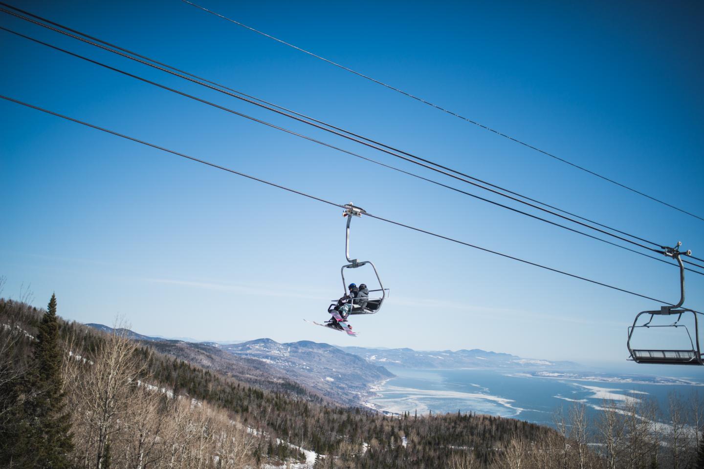 Skieurs dans les chaises devant le paysage du Massif