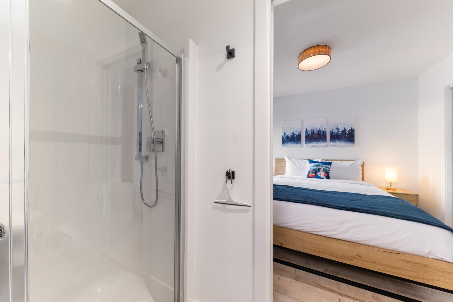 Chambre moderne avec lit double et salle de bain attenante.