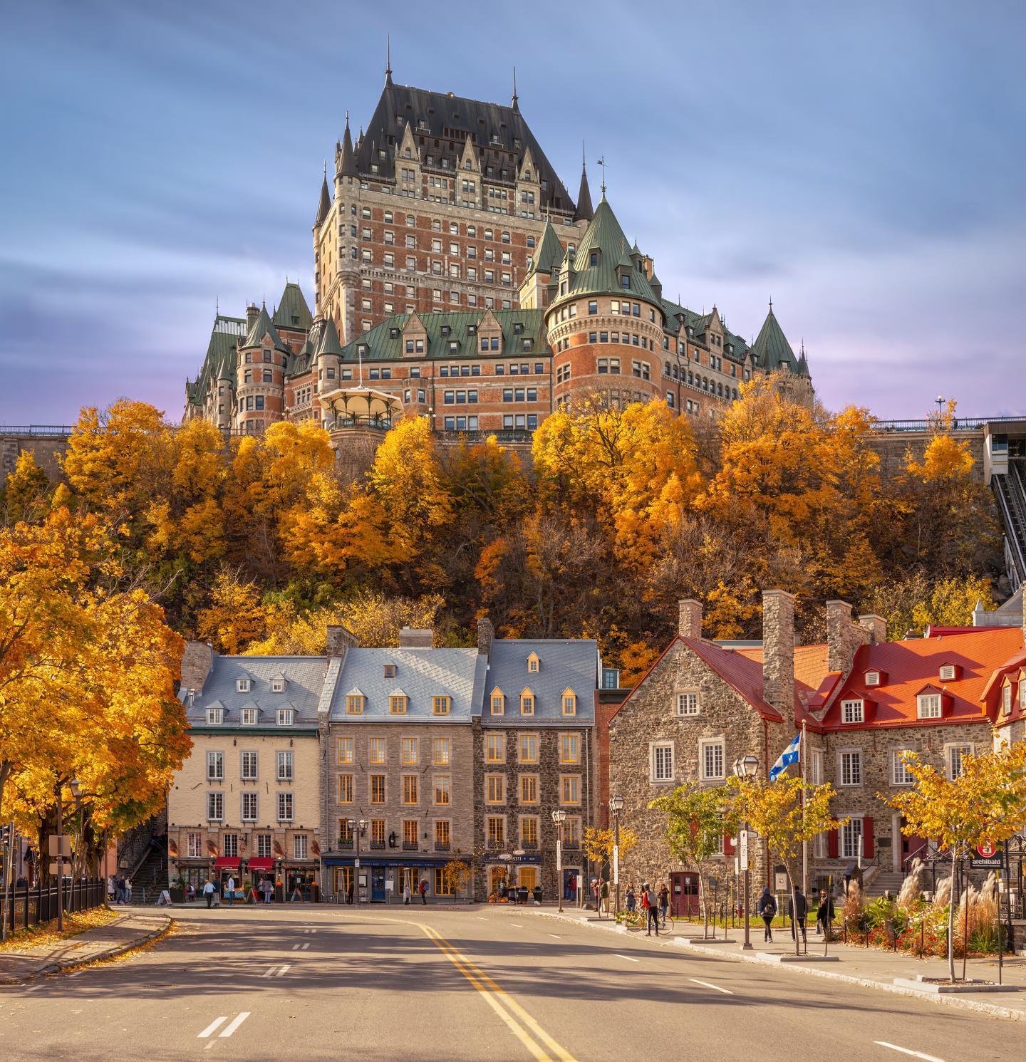 Château Frontenac dominant les arbres d’automne et les maisons de Québec.
